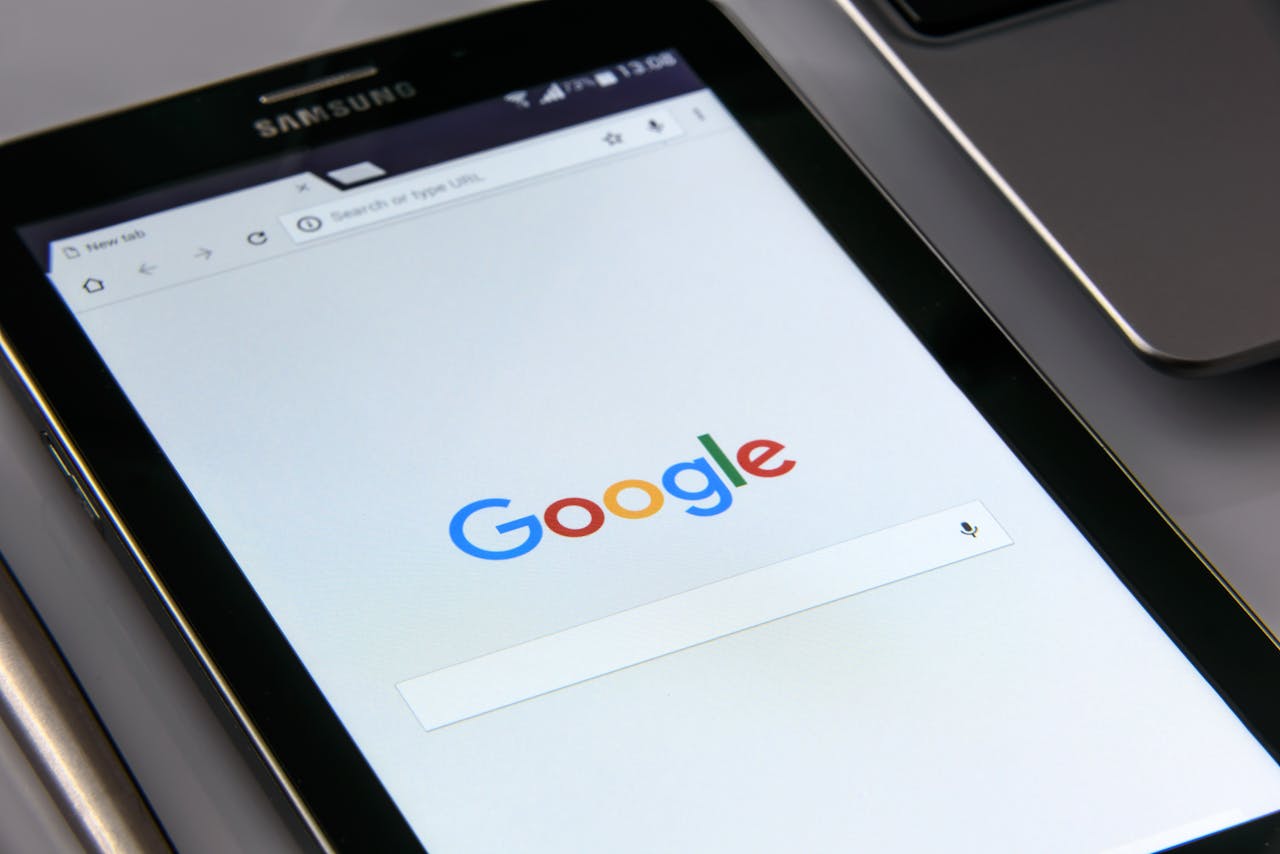 about-01 Close-up of a tablet displaying Googles search screen, emphasizing technology and internet browsing.